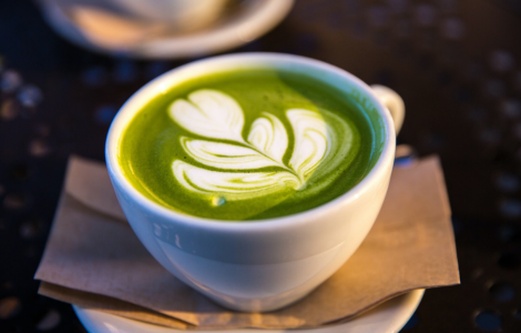 white ceramic teacup filled of matcha tea